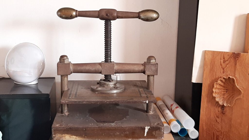 Image of a marquetry press used to secure wooden pieces while they are glued and intricate designs are formed. This essential tool in marquetry helps maintain stability and precision during the assembly of the pieces.