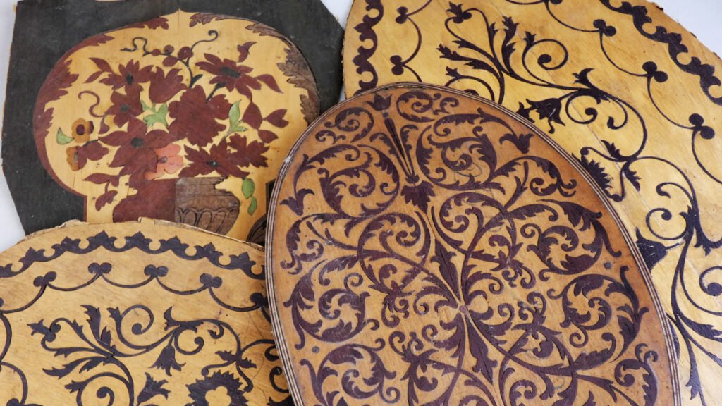Selection of vintage marquetry with classic designs, typical of antique furniture. These detailed wood inlay patterns showcase the craftsmanship and artistry of past eras.