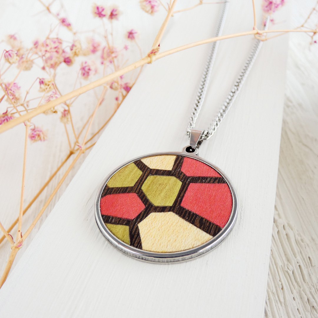 Colgante de madera hecha a mano con madera natural y teñida inspirado en el diseño del mosaico Trencadís de Gaudí.