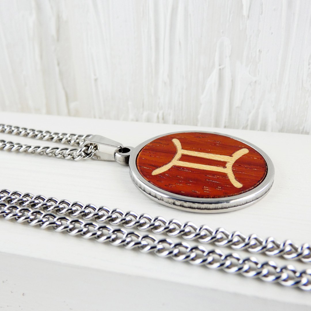 Colgante Géminis hecho a mano con vibrante madera de coral y acero inoxidable