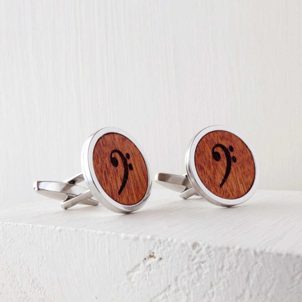 Gemelos clave de fa de madera con un elegante símbolo musical grabado en una base metálica de acero inoxidable.
