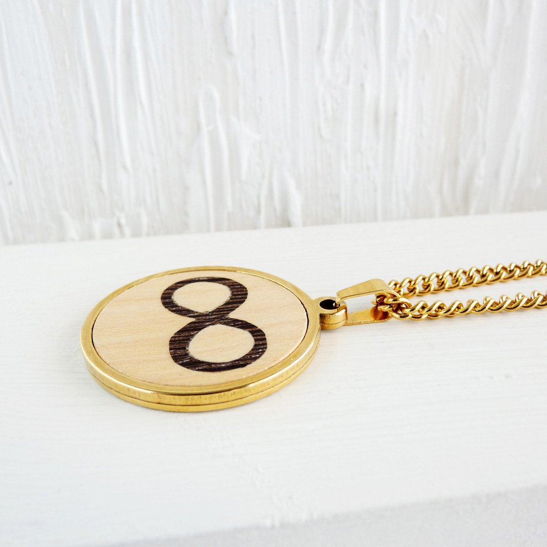 Vista lateral del colgante infinito de madera que muestra su ligereza y grosor.
